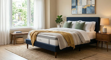 Puffy Lux mattress displayed on a bed frame in a bedroom.